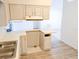 Bright kitchen area with white cabinets and modern laminate flooring at 11847 Ocklawaha Dr, Leesburg, FL 34788