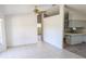 Open-concept living room featuring neutral tile flooring that leads to the kitchen area, bright and airy at 11847 Ocklawaha Dr, Leesburg, FL 34788