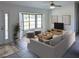 Bright living room featuring a bay window, neutral color palette, and stylish furnishings at 11847 Ocklawaha Dr, Leesburg, FL 34788