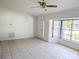 Well-lit living room with tiled floor, bay windows, and a front door at 11847 Ocklawaha Dr, Leesburg, FL 34788