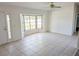 Living room featuring large windows, ceiling fan, and neutral flooring at 11847 Ocklawaha Dr, Leesburg, FL 34788