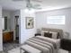 Staged main bedroom with new floors, light colored walls and ceilings, closet and sunny window at 11847 Ocklawaha Dr, Leesburg, FL 34788