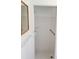 Clean shower with white tile, grab bar, and shower accessories at 11847 Ocklawaha Dr, Leesburg, FL 34788