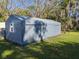 Large storage shed with double doors and a window offers ample space for tools and equipment at 11847 Ocklawaha Dr, Leesburg, FL 34788