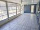 Enclosed sun room featuring tiled floors, ceiling fans, and screened windows at 11847 Ocklawaha Dr, Leesburg, FL 34788