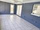 Bright sunroom featuring tiled flooring, fan, and access to the exterior, perfect for relaxing or entertaining guests at 11847 Ocklawaha Dr, Leesburg, FL 34788