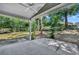 A view of the backyard and shade trees from the covered back porch with concrete flooring at 119 Winterglen Dr Dr, Sanford, FL 32771