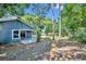 View of the backyard from the back of the house with trees and grass at 119 Winterglen Dr Dr, Sanford, FL 32771