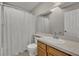 Well-lit bathroom featuring a vanity with sink, toilet, and shower-tub with a curtain at 119 Winterglen Dr Dr, Sanford, FL 32771