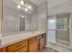 Bathroom with a large mirror over vanity, and a walk-in shower with glass doors at 119 Winterglen Dr Dr, Sanford, FL 32771