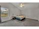 Neutral bedroom featuring a bed, nightstand, lamp, and large window at 119 Winterglen Dr Dr, Sanford, FL 32771