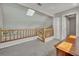 Bright hallway area with skylight, wood railing to stairs, and adjacent double door closet at 119 Winterglen Dr Dr, Sanford, FL 32771