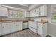 Bright kitchen showcasing white appliances, laminate countertops, and ample storage space at 119 Winterglen Dr Dr, Sanford, FL 32771