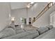 Open living room with vaulted ceilings, staircase, and sliding glass doors to the backyard at 119 Winterglen Dr Dr, Sanford, FL 32771