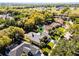 Aerial view showcases a home with screened in pool and mature trees, pinpointed with a green marker at 1367 Saddleridge Dr, Orlando, FL 32835