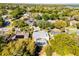 Beautiful aerial view of a home featuring a screened-in pool surrounded by lush greenery at 1367 Saddleridge Dr, Orlando, FL 32835