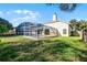 View of the backyard showing the enclosed pool with a well-maintained lawn and partial fencing at 1367 Saddleridge Dr, Orlando, FL 32835