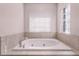 This bathroom features a large white tub and window at 1367 Saddleridge Dr, Orlando, FL 32835