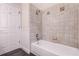 Bathroom showcases tiled shower walls and a bathtub, complemented by a white door at 1367 Saddleridge Dr, Orlando, FL 32835