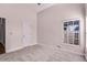 This bedroom offers a large window for natural light and soft gray carpet at 1367 Saddleridge Dr, Orlando, FL 32835