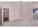 This is a bedroom with an open door, beige walls and gray carpet at 1367 Saddleridge Dr, Orlando, FL 32835