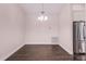 Bright dining room with modern lighting, stainless refrigerator and light neutral walls at 1367 Saddleridge Dr, Orlando, FL 32835