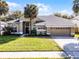 Charming single Gathering home featuring a well-manicured lawn and attached two car garage at 1367 Saddleridge Dr, Orlando, FL 32835