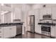 Open kitchen design featuring stainless steel appliances, white cabinets, and granite countertops at 1367 Saddleridge Dr, Orlando, FL 32835