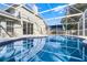 Outdoor screened in pool area with beautiful tiling and ample space for relaxing in the sun at 1367 Saddleridge Dr, Orlando, FL 32835