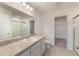 Bathroom vanity with a large mirror and view to a shower and walk-in closet at 1409 Dalkeith Cv, Sanford, FL 32771