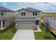 Charming two-story home with a gray exterior, two-car garage and nicely manicured front lawn at 1409 Dalkeith Cv, Sanford, FL 32771