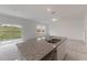 Kitchen island featuring granite countertops, stainless steel sink, and ample counter space at 1409 Dalkeith Cv, Sanford, FL 32771