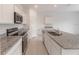 Kitchen boasts white cabinets, granite counters, and stainless steel appliances at 1409 Dalkeith Cv, Sanford, FL 32771