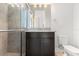Bathroom with a glass door shower and dark cabinets at 14165 Moniz Ave, Orlando, FL 32827