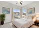 Bright bedroom featuring a ceiling fan, neutral walls, and a sliding glass door to a patio at 14165 Moniz Ave, Orlando, FL 32827