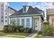 Charming home with a gray roof, blue trim, and well-maintained landscaping and a paver walkway at 14165 Moniz Ave, Orlando, FL 32827