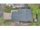 An overhead shot of a home with a new roof, brick driveway, and well-maintained yard surrounded by greenery at 1517 E Esther St, Orlando, FL 32806