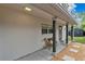 Cozy porch featuring dark columns, seating area, and a well-maintained yard at 1517 E Esther St, Orlando, FL 32806
