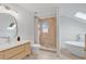 Bright bathroom featuring a walk-in shower, soaker tub and a skylight at 1517 E Esther St, Orlando, FL 32806