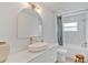 Bright bathroom features white countertops, sleek faucet, and a modern, round mirror at 1517 E Esther St, Orlando, FL 32806
