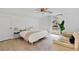 Bright bedroom featuring a ceiling fan, sofa and large window offering outside view at 1517 E Esther St, Orlando, FL 32806