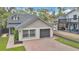 Beautiful home featuring a brick driveway, attached garage, manicured lawn, and mature landscaping at 1517 E Esther St, Orlando, FL 32806
