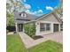 Charming single-story home with a brick walkway, well-kept lawn, and fresh exterior paint at 1517 E Esther St, Orlando, FL 32806