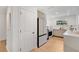 Bright kitchen features modern appliances, white countertops, and light hardwood floors at 1517 E Esther St, Orlando, FL 32806