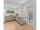 Bright kitchen features modern appliances, white countertops, and light hardwood floors at 1517 E Esther St, Orlando, FL 32806