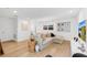 Spacious living room features light hardwood floors, modern furniture, and white paint at 1517 E Esther St, Orlando, FL 32806