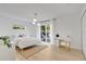 Bright bedroom features hardwood floors, natural light, and a sliding glass door at 1517 E Esther St, Orlando, FL 32806