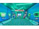 Vibrant arcade game room with multiple stations and comfy seating for entertainment at 159 Captiva Dr, Davenport, FL 33896