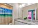 Dual sink bathroom with granite countertops, decorative shower curtain, and adjoining bedroom at 159 Captiva Dr, Davenport, FL 33896