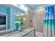 Bathroom with granite countertops, double sinks and a shower/tub with decorative shower curtain at 159 Captiva Dr, Davenport, FL 33896
